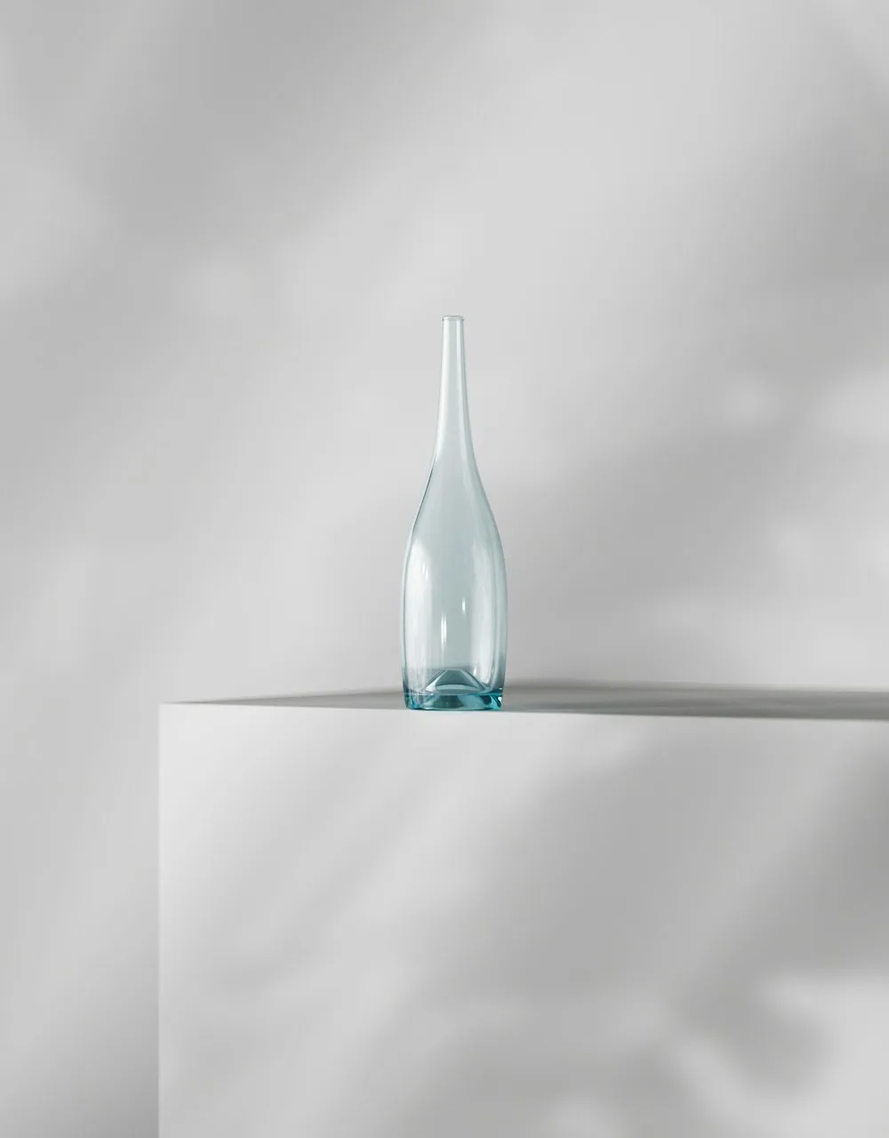 A blue glass bottle on a white plinth
